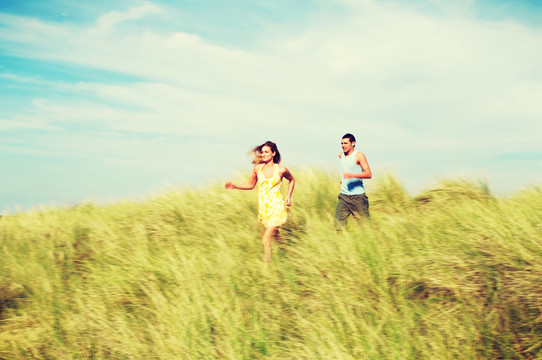 在草地上奔跑的夫妇