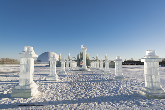 夕阳下雪原上晶莹剔透的冰雕建筑