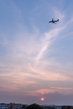 日落下在空中飞行的客机飞机