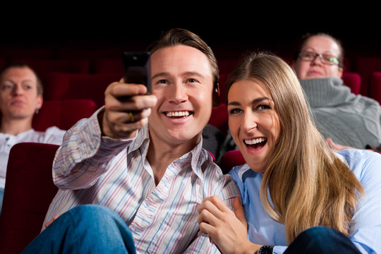 夫妇和其他人，可能是朋友，在电影院看电影时，他们试图切换到另一个在电影院不可能的节目