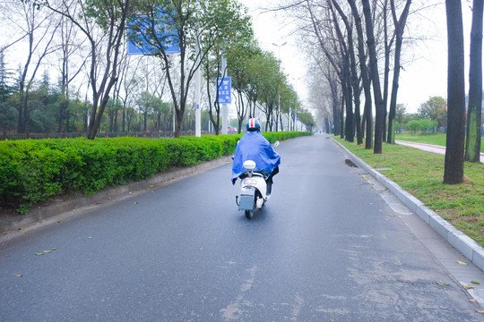 穿雨披骑车男子