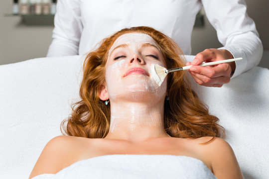 在美容或健康治疗过程中使用面膜或面霜的妇女