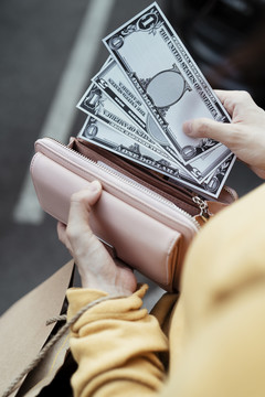 女人从钱包或皮夹里取现金的手，加速钱，买，买。