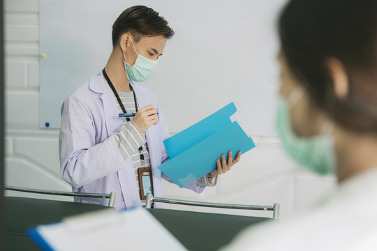 医生戴着口罩，护士拿着剪贴板。