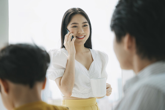 一家人住在城里的公寓里，妈妈接到老板的电话，爸爸教儿子做作业。