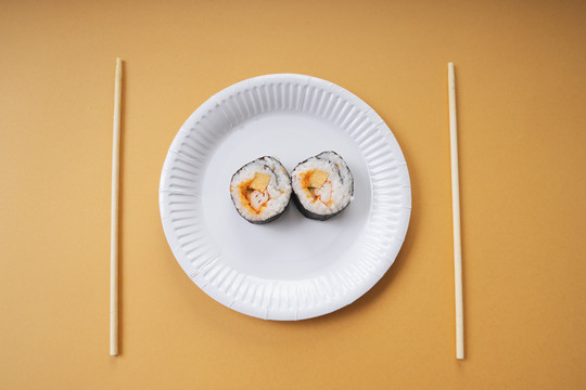 俯视图-饭桌上的纸盘上的Maki卷寿司。