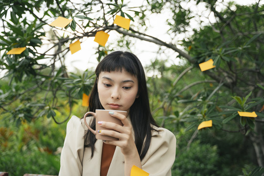 忙碌的亚洲女商人穿着正式的衬衫，贴着便签。