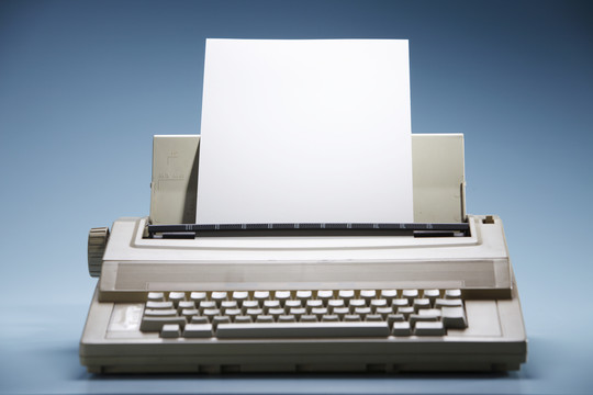 装有白纸的老式电子打字机。