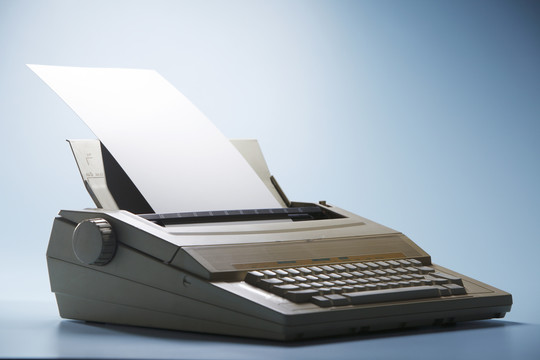 装有白纸的老式电子打字机。