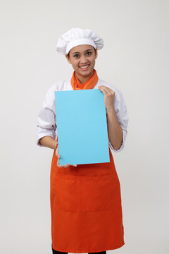 穿着厨师制服的印度女人拿着一张空白卡片