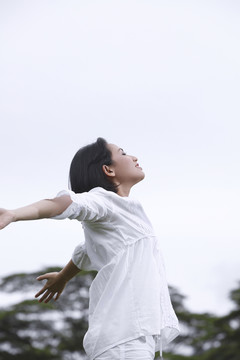 女人伸出双臂的侧视图