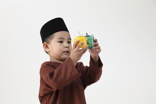 马来男孩在玩五颜六色的佩利塔