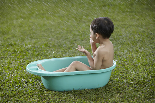 马来男孩在户外洗澡