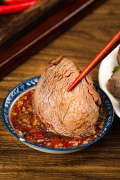 筷子上夹着卤牛肉