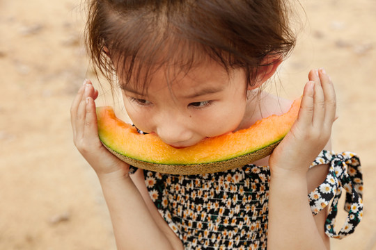 小女孩正在吃哈密瓜