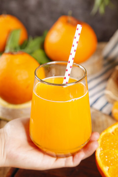 手里拿着一杯橘柑汁