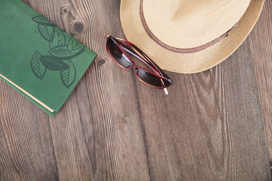 休闲帽子和太阳眼镜及一个笔记本