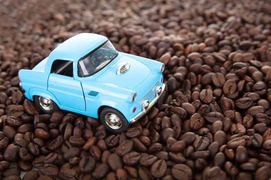 行驶在一堆咖啡豆上的小汽车模型