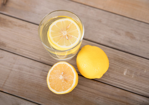 俯视桌子上一杯柠檬水和鲜柠檬果