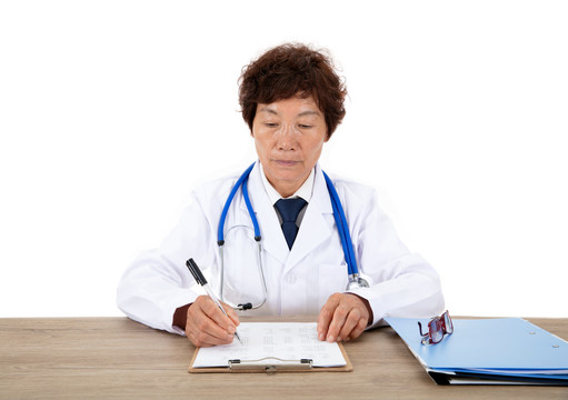 中国女医生正坐在桌子前工作