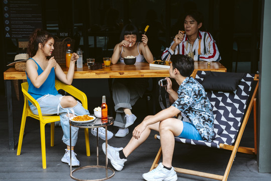 一群亚洲年轻人在酒店休息室享受夏日旅行的乐趣。