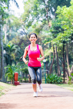 亚洲女子在公园跑步健身和运动，热带环境