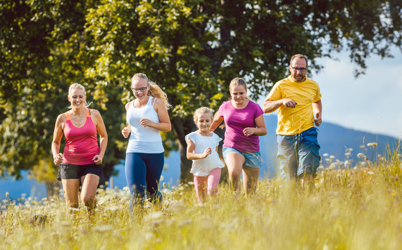 家人、母亲、父亲和孩子们在草地上跑步运动