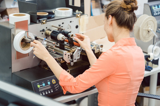 在标签印刷机上工作的妇女的特写镜头
