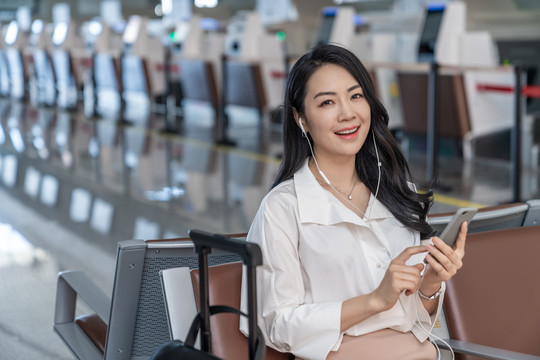商务女士在机场使用手机