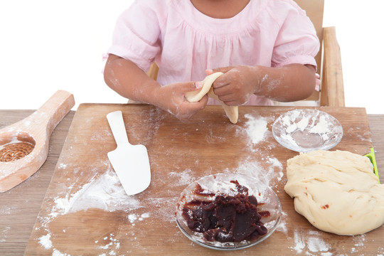 小孩子在学习制作面食糕点