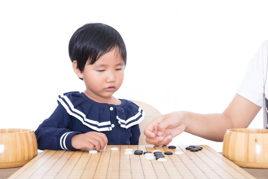 老师在辅导孩子如何下围棋