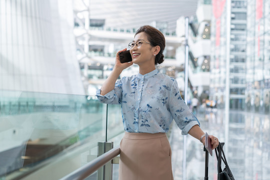 老年女人在机场打电话