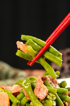筷子上夹着豆角炒肉