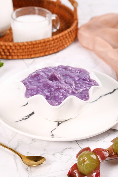 盘子里放着一碗紫薯粥