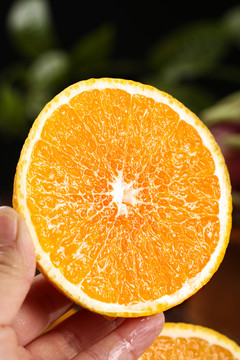 手里拿着半边切面的橘柚