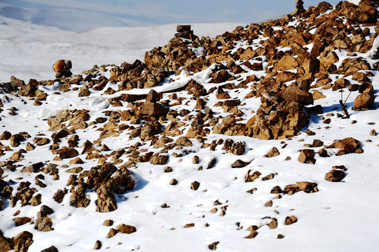 铺满积雪的山坡上都是碎石