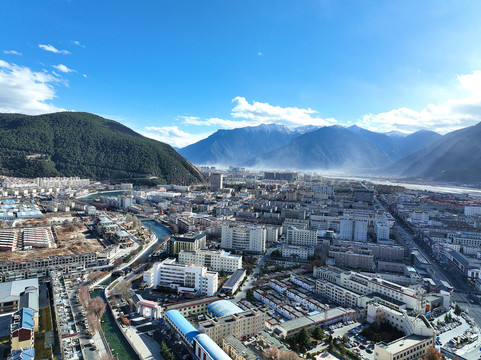 航拍西藏林芝市区冬季雪山