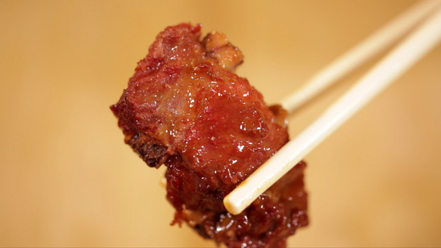 筷子夹起排骨肉