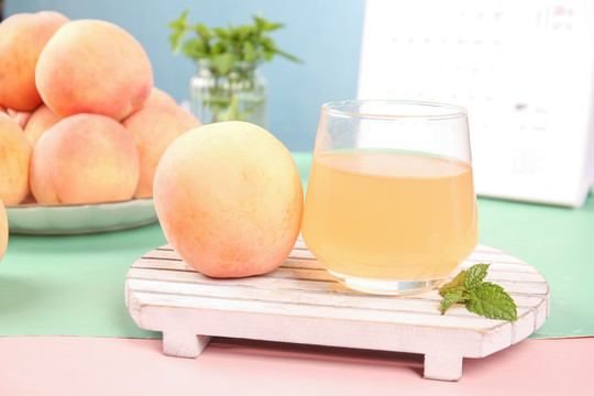 木板上放着水蜜桃和桃子汁