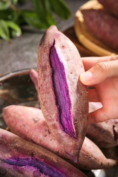 手上拿着蒸熟的紫薯