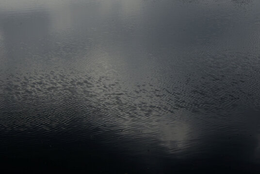 乌云密布的天空倒影在湖面上
