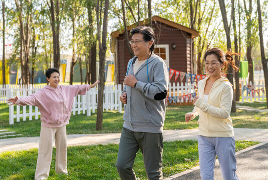 一群中老年人微笑着跑步健身