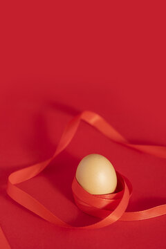 红丝带包裹的鸡蛋红色背景
