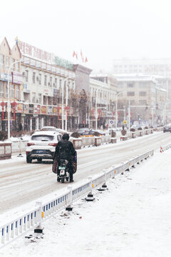 冬季雪后街道行驶的摩托车