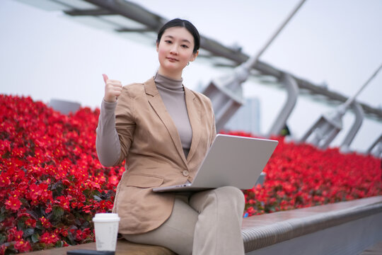 自信女性在户外用笔记本工作