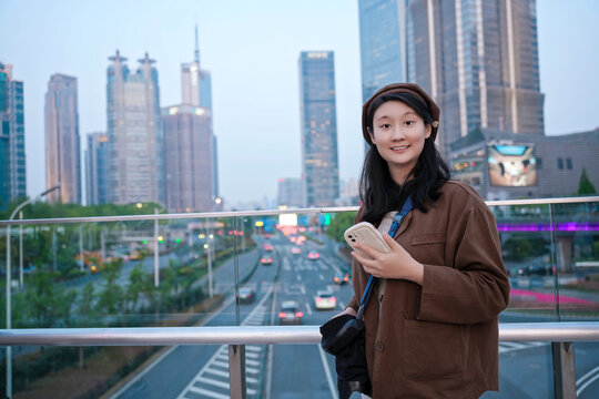 年轻女性在城市景观中检查手机