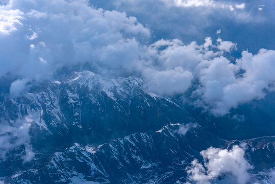 航拍中国新疆的蓝天白云雪山