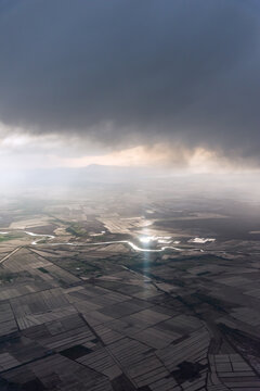 航拍积雨云下中国新疆的田野河流