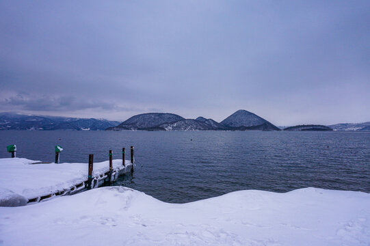 冬日雪覆湖畔码头景致
