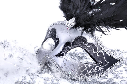 close on carnival mask with black feather in confe